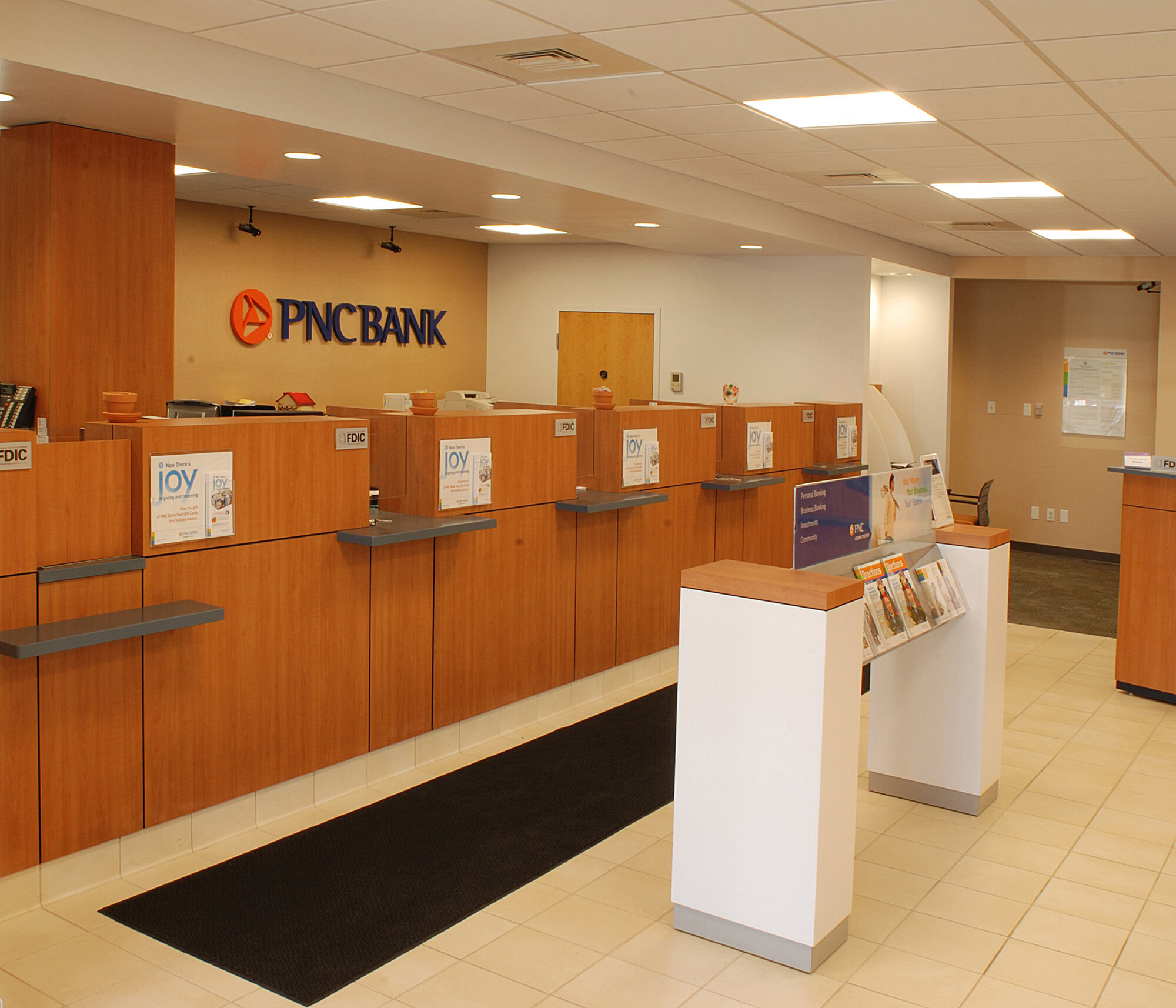 a bank reception area with a sign.